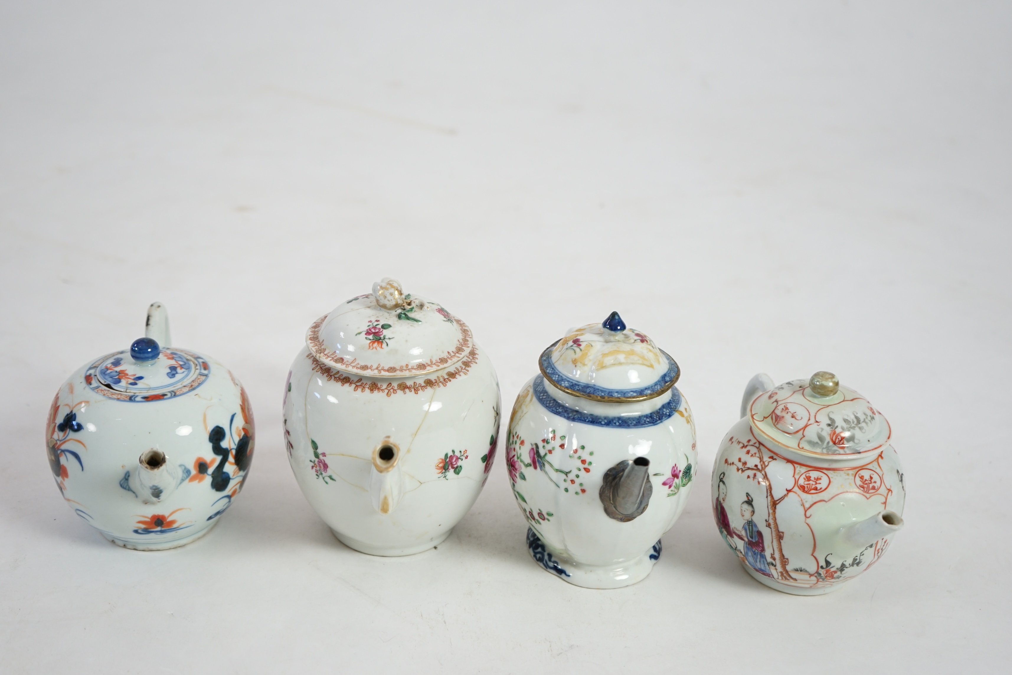 Four 18th century Chinese export polychrome decorated teapots and covers